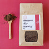 Organic caffeine-free Rooibos tea package labeled Align by The Red Tea Co. with loose leaf tea on wooden spoon on red background