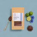 A stand-up kraft paper pouch of Rooibos Eel Grey tea with a clear window showing the loose tea inside, set against a plain white background.
