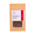 A stand-up kraft paper pouch of Rooibos Hibiscus & Rosehips Caffeine Free Tea, featuring a white and red label with a clear window showing the loose tea leaves inside, set against a plain white background.