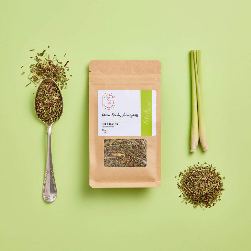 A stand-up kraft paper pouch of Green Rooibos & Lemongrass caffeine-free tea, featuring a white and green label with a clear window showing the loose tea inside, set against a plain white background.