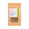 A stand-up kraft paper pouch of Green Rooibos & Lemongrass caffeine-free tea, featuring a white and green label with a clear window showing the loose tea inside, set against a plain white background.