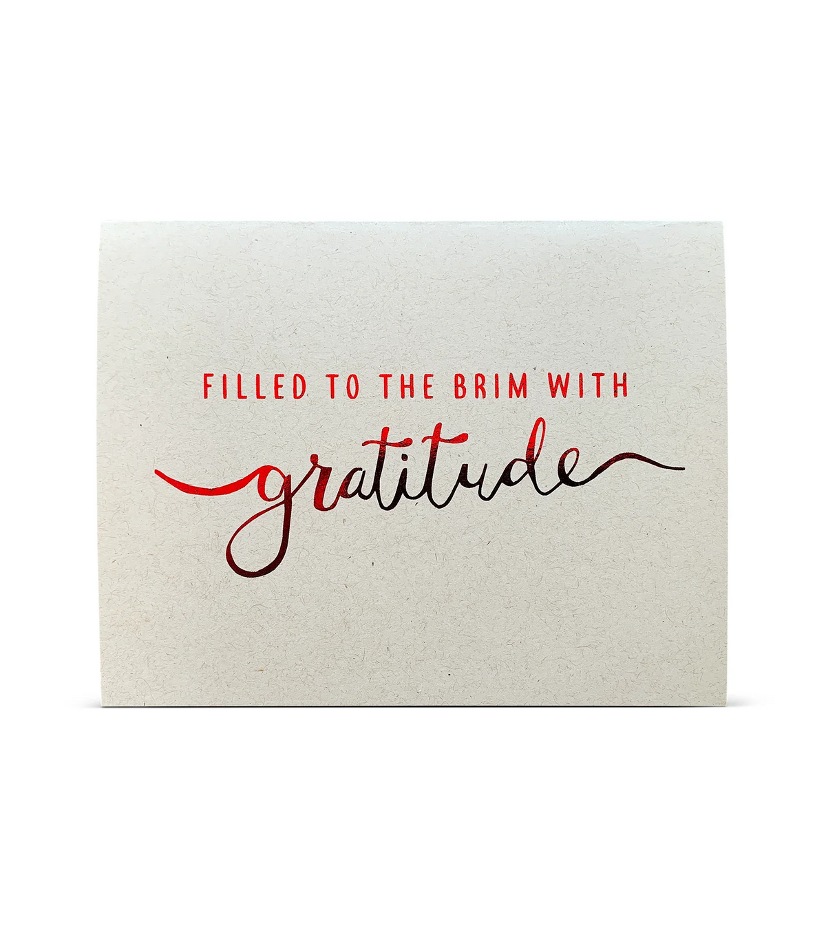 Card with red and black text saying filled to the brim with gratitude on textured beige background